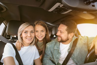 Happy family on road trip. Parents with daughter in car