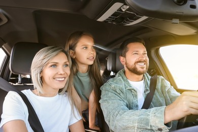 Image of Happy family on road trip. Parents with daughter in car