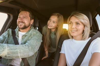 Happy family on road trip. Parents with daughter in car