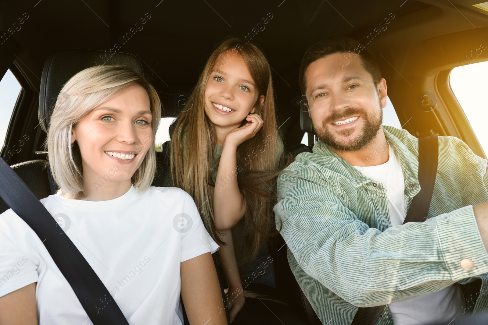 Image of Happy family on road trip. Parents with daughter in car