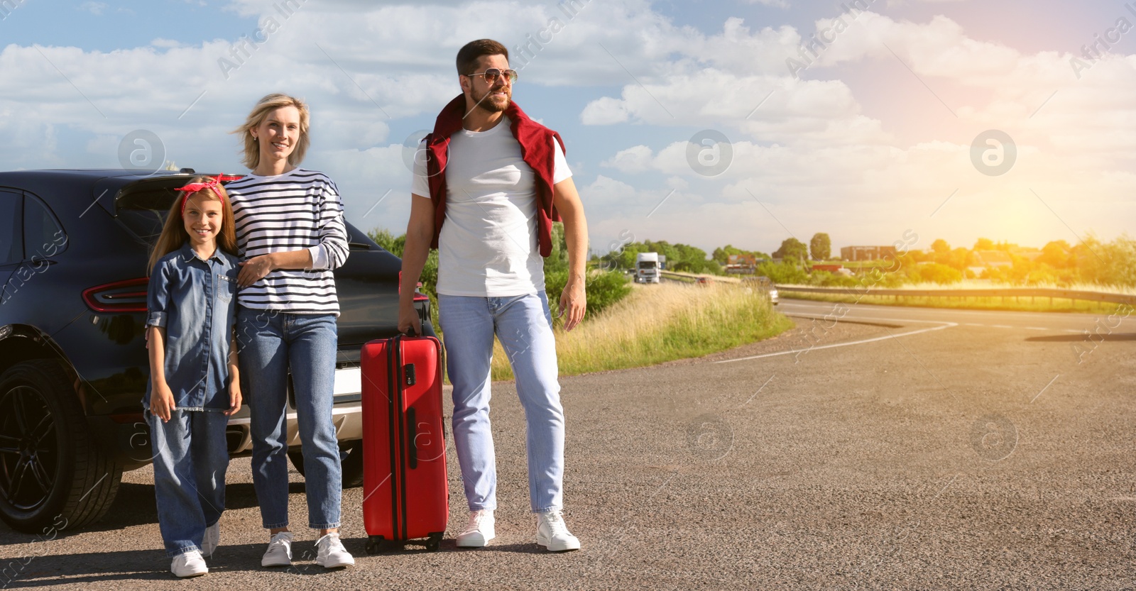 Image of Happy family near car on road trip. Banner design with space for text