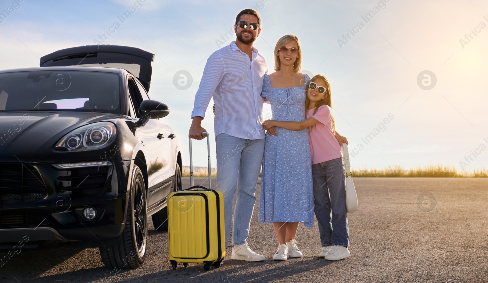 Image of Happy family near car on road trip. Banner design with space for text