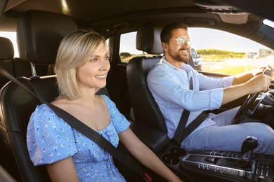 Image of Happy family enjoying trip together by car on sunny day, view from outside