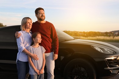 Happy family enjoying road trip. Parents and daughter near car