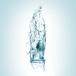 Image of Water splashing in contour of bottle on turquoise background