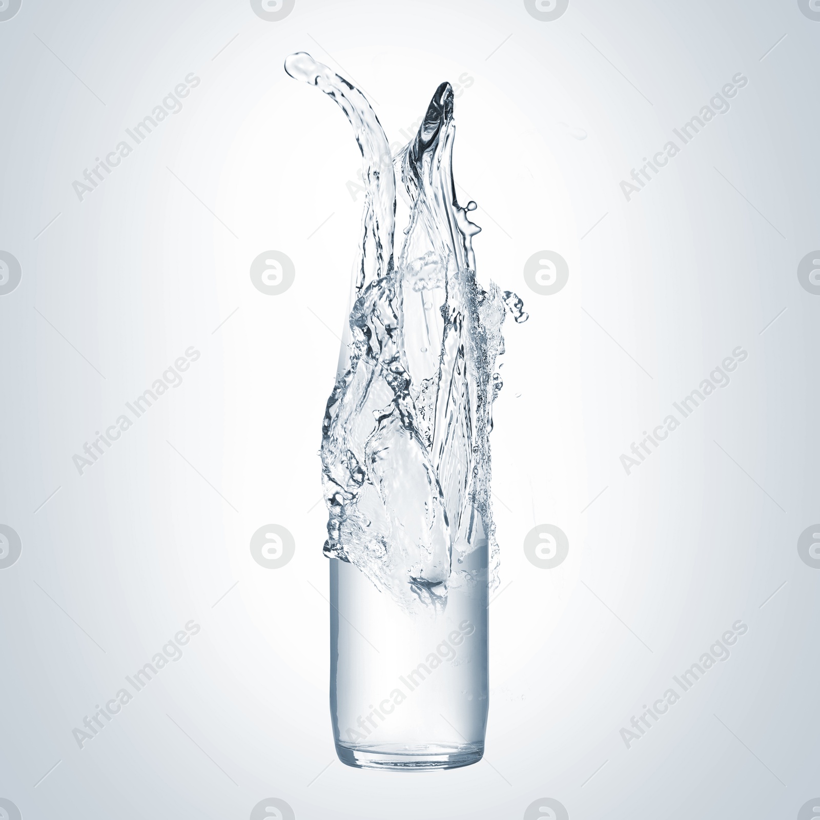 Image of Splashing water continuing shape of bottle on light background