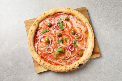 Photo of Delicious vegetarian pizza on light grey background, top view