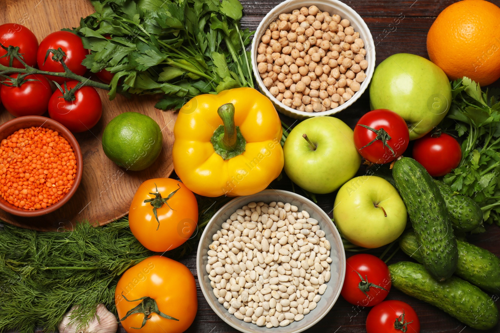 Photo of Different vegetarian products on wooden table, top view