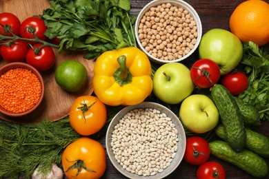 Different vegetarian products on wooden table, top view