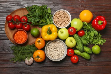 Photo of Different vegetarian products on wooden table, top view