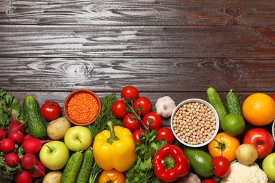 Different vegetarian products on wooden table, top view. Space for text