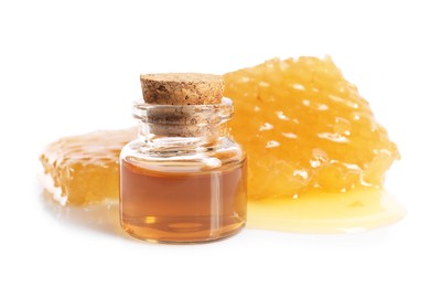 Photo of Natural honey tincture and sweet honeycombs isolated on white