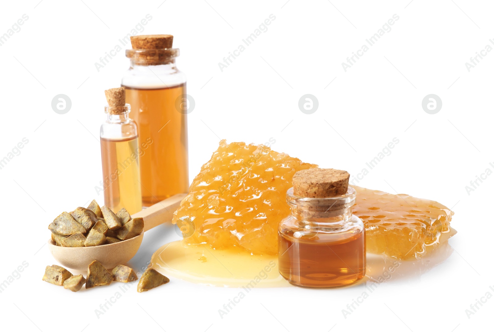 Photo of Natural honey tincture, propolis granules and sweet honeycombs isolated on white