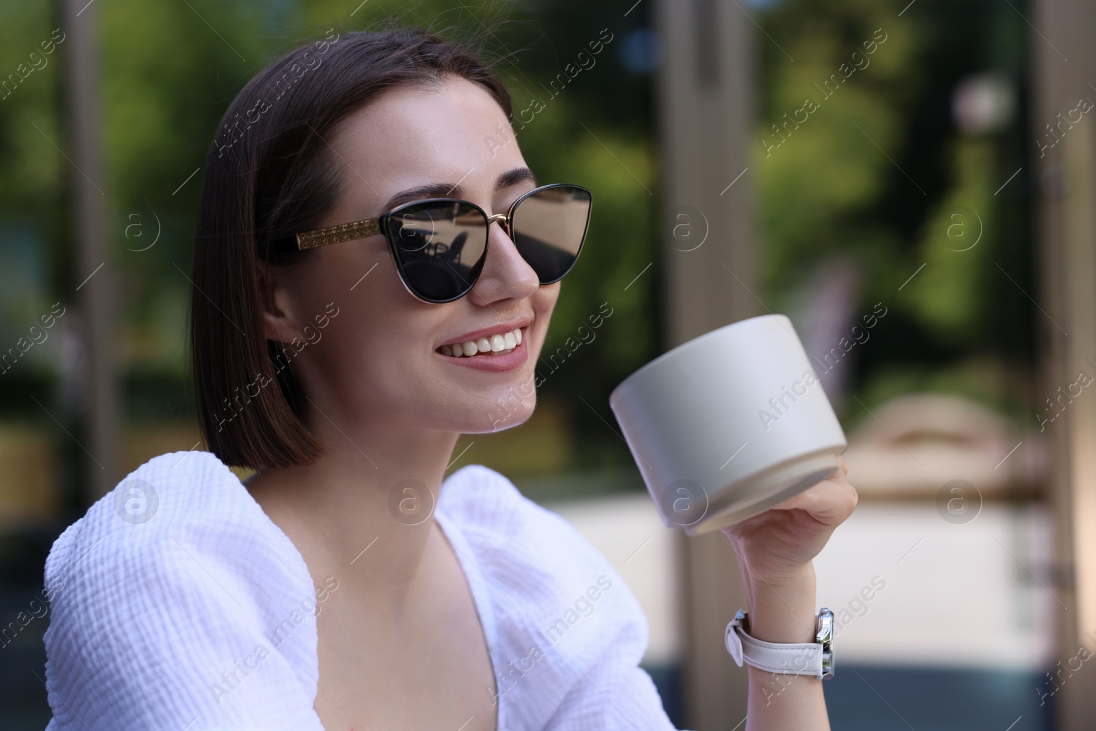 Photo of Happy woman having breakfast in outdoor cafe