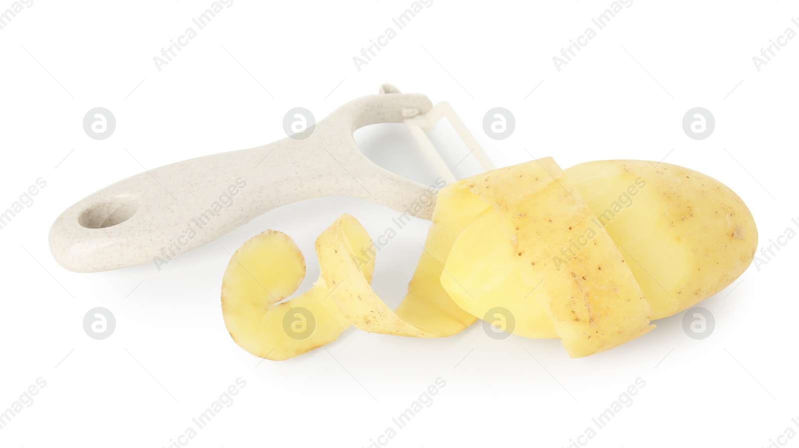 Photo of Young potato, peel and peeler isolated on white