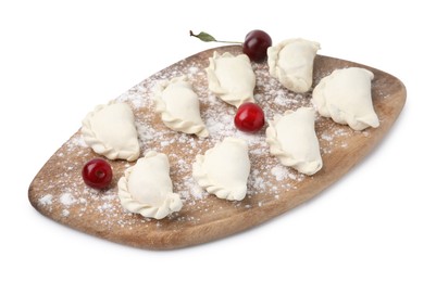 Photo of Raw dumplings (varenyky) and fresh cherries isolated on white