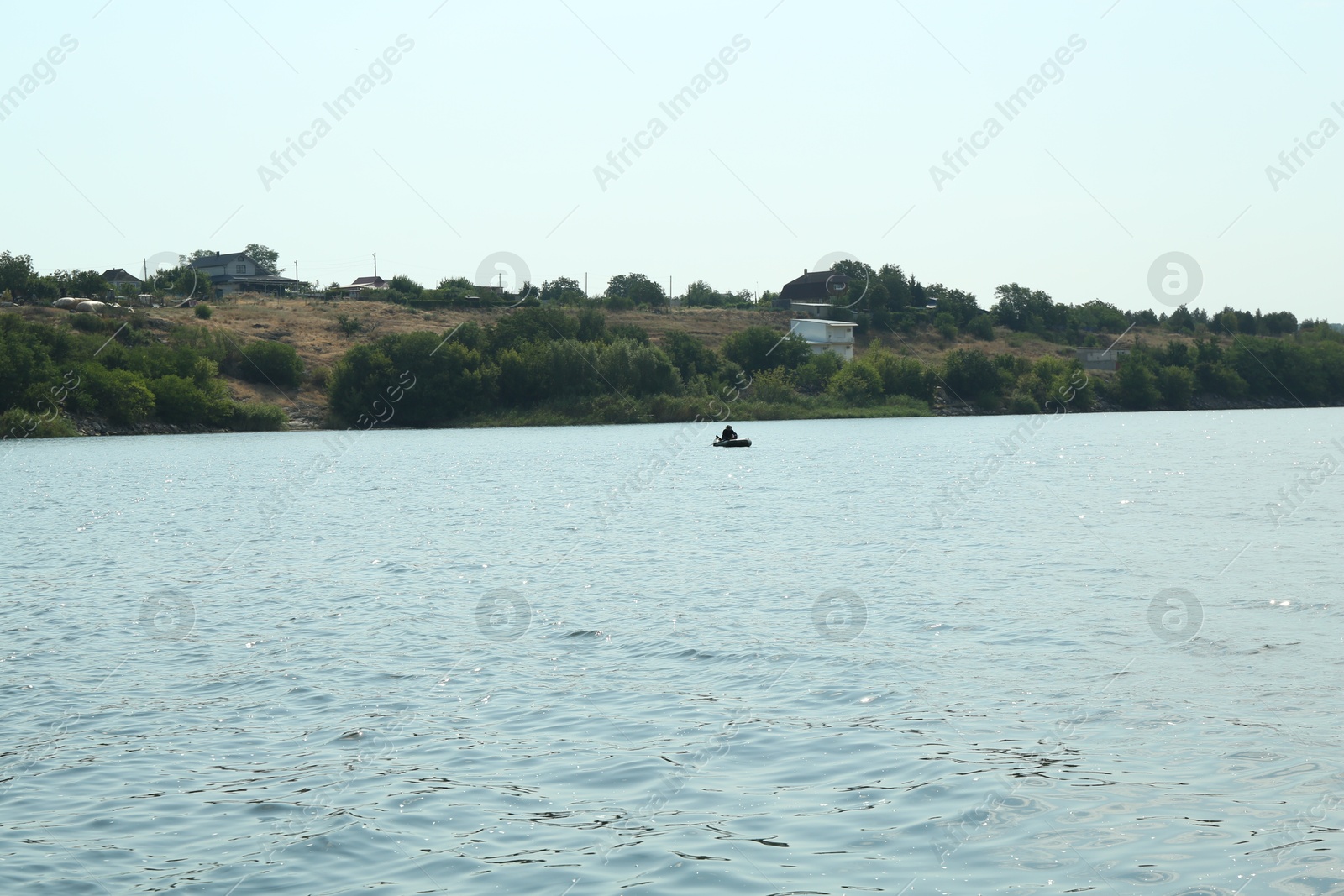 Photo of Picturesque view of lake, boat and trees outdoors