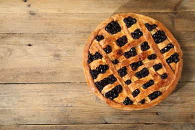 Photo of Tasty homemade pie with blueberries on wooden table, top view. Space for text