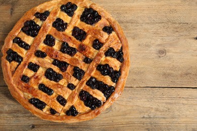 Photo of Tasty homemade pie with blueberries on wooden table, top view. Space for text