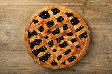 Photo of Tasty homemade pie with blueberries on wooden table, top view