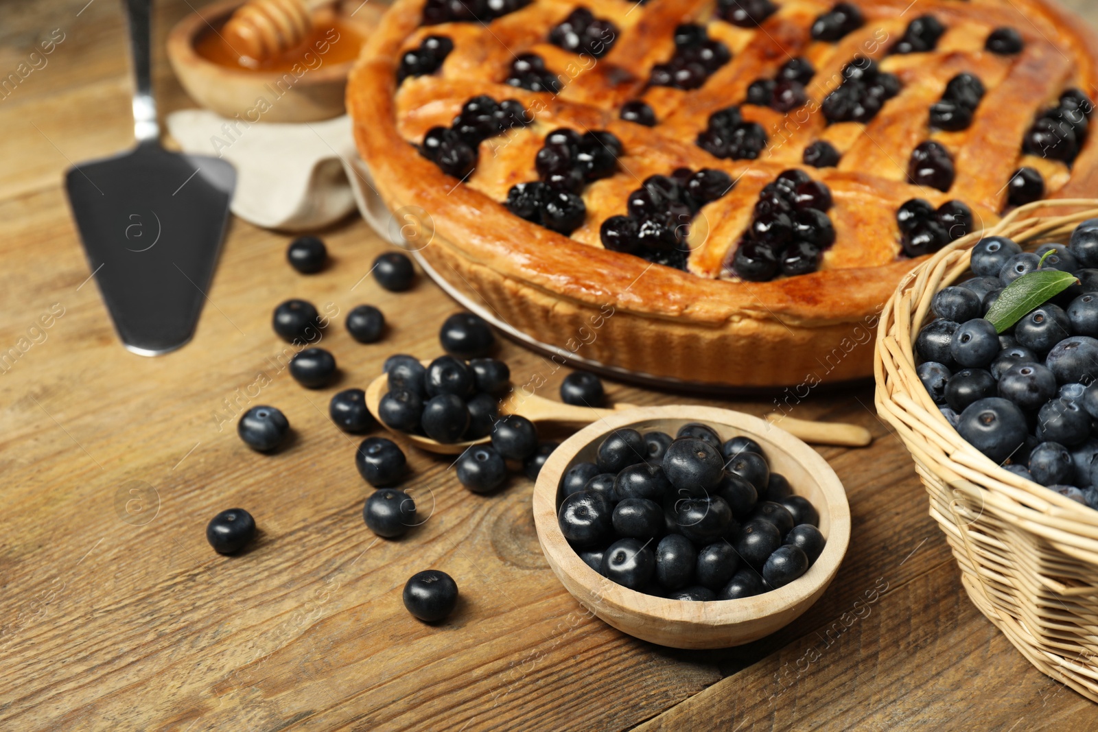 Photo of Tasty homemade pie with blueberries served on wooden table