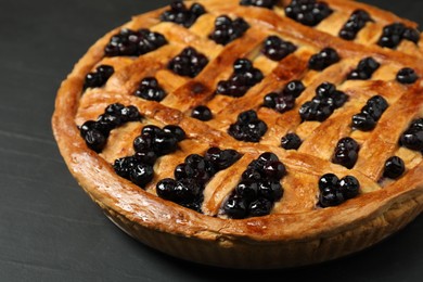 Photo of Tasty homemade pie with blueberries on grey table, closeup