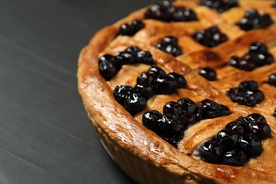 Photo of Tasty homemade pie with blueberries on grey table, closeup