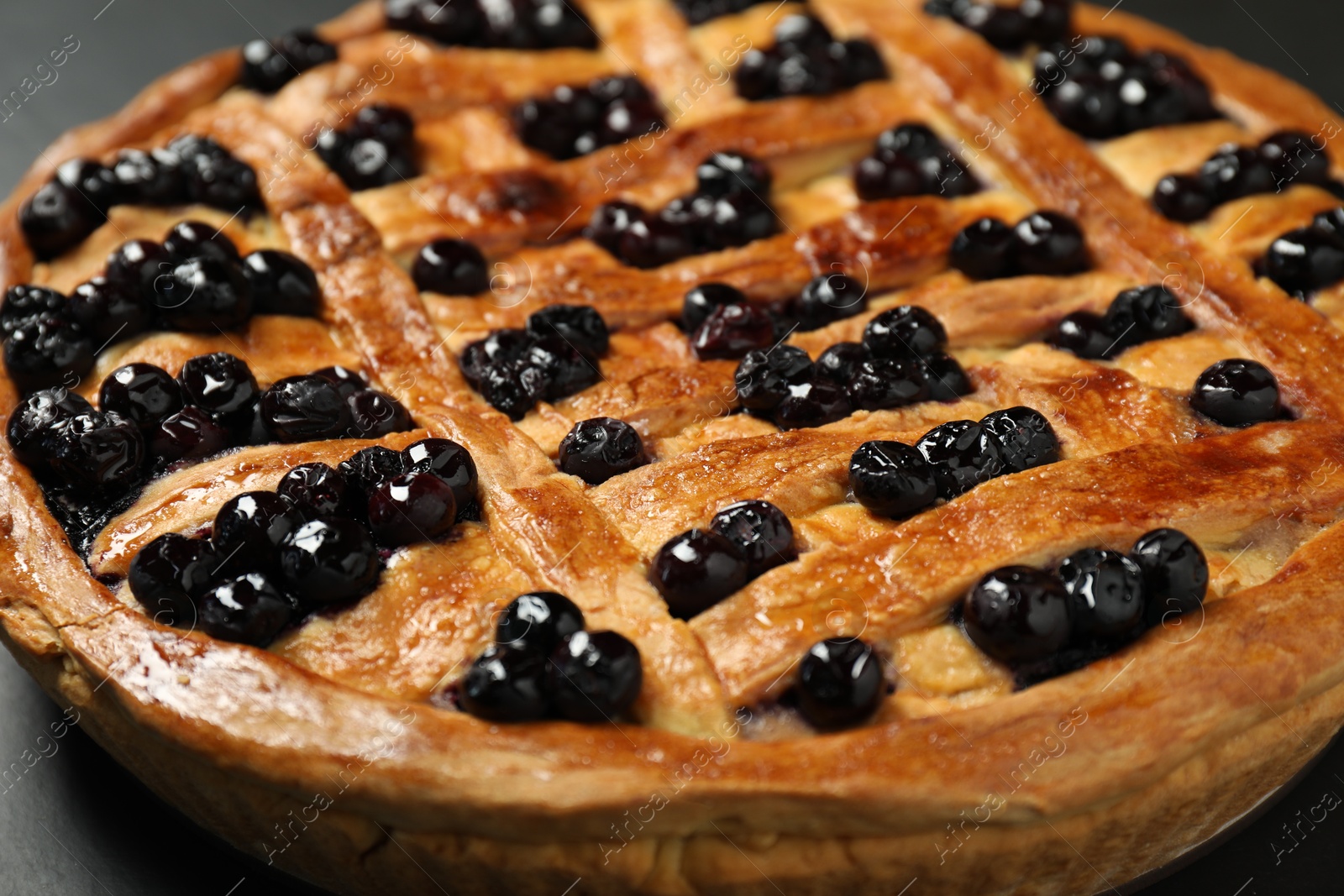 Photo of Tasty homemade pie with blueberries on table, closeup