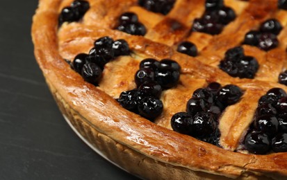 Photo of Tasty homemade pie with blueberries on grey table, closeup