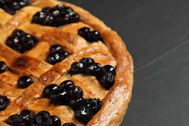 Photo of Tasty homemade pie with blueberries on grey table, closeup