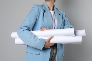 Photo of Engineer with drafts on grey background, closeup