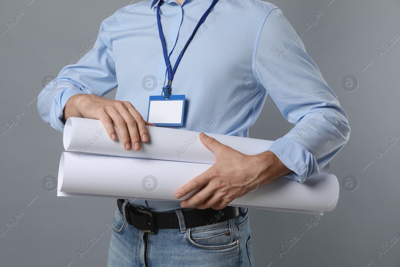 Photo of Engineer with drafts on grey background, closeup