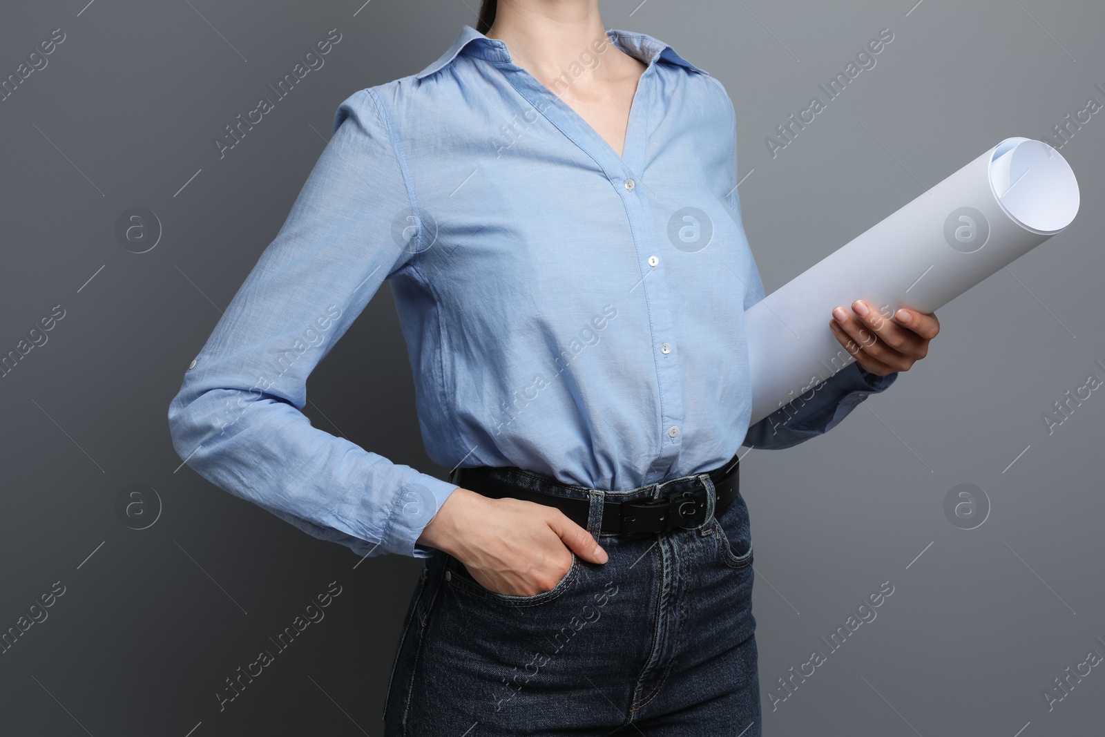 Photo of Engineer with draft on grey background, closeup