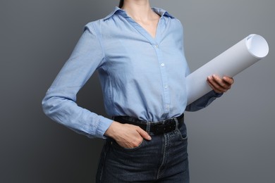 Photo of Engineer with draft on grey background, closeup