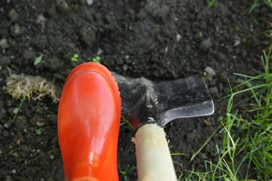 Photo of Farmer digging soil with shovel, above view