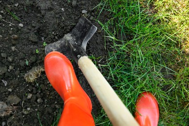 Farmer digging soil with shovel, above view