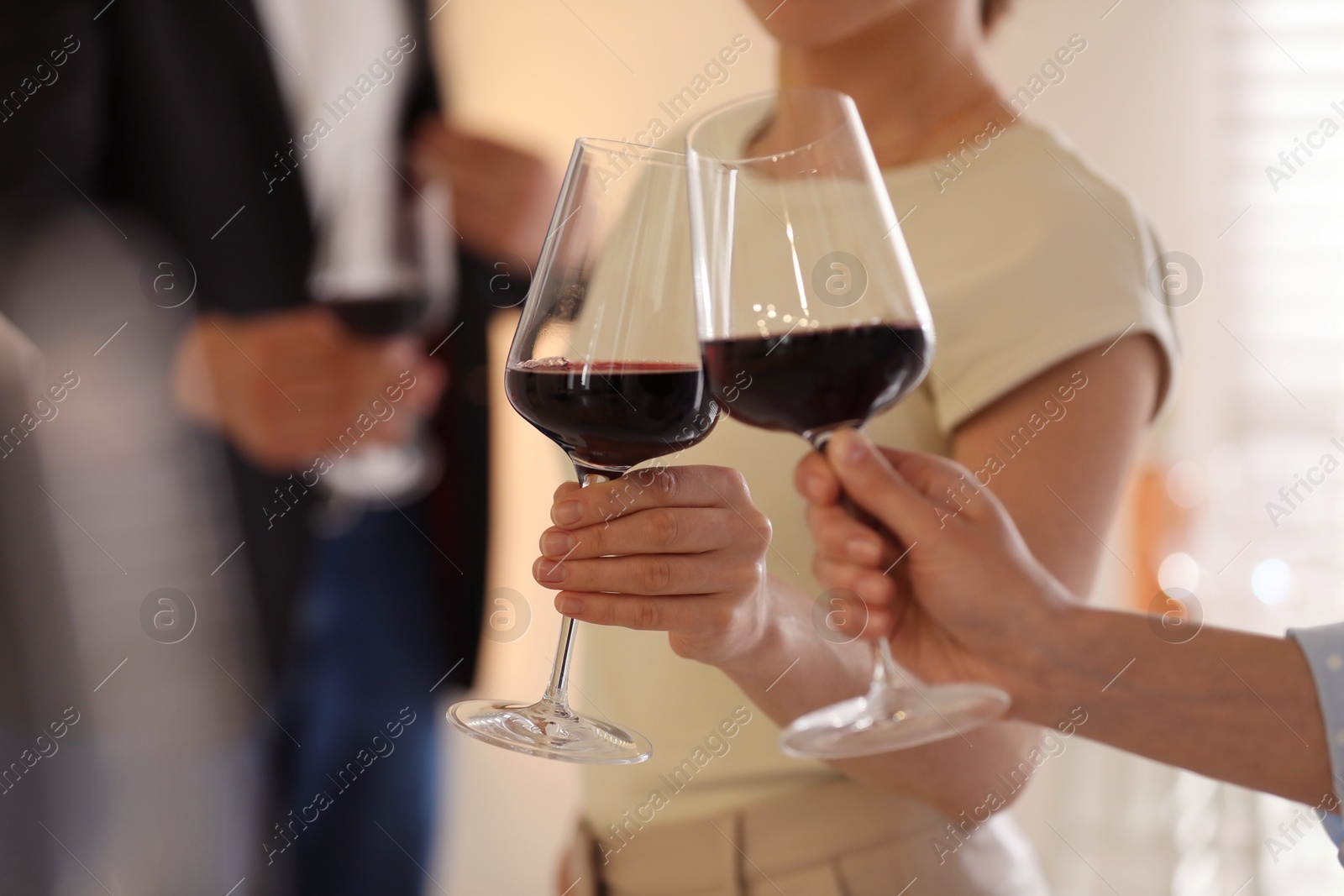 Photo of Friends with glasses of red wine, selective focus