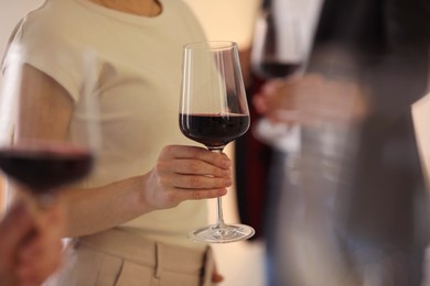 Photo of Friends with glasses of red wine, selective focus