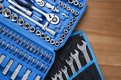 Different auto mechanic's tools on wooden table, top view