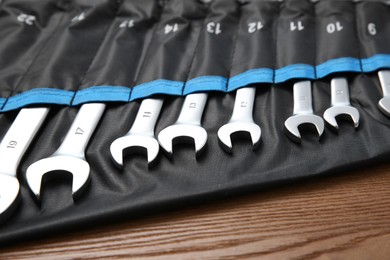 Auto mechanic's tools in case on wooden table