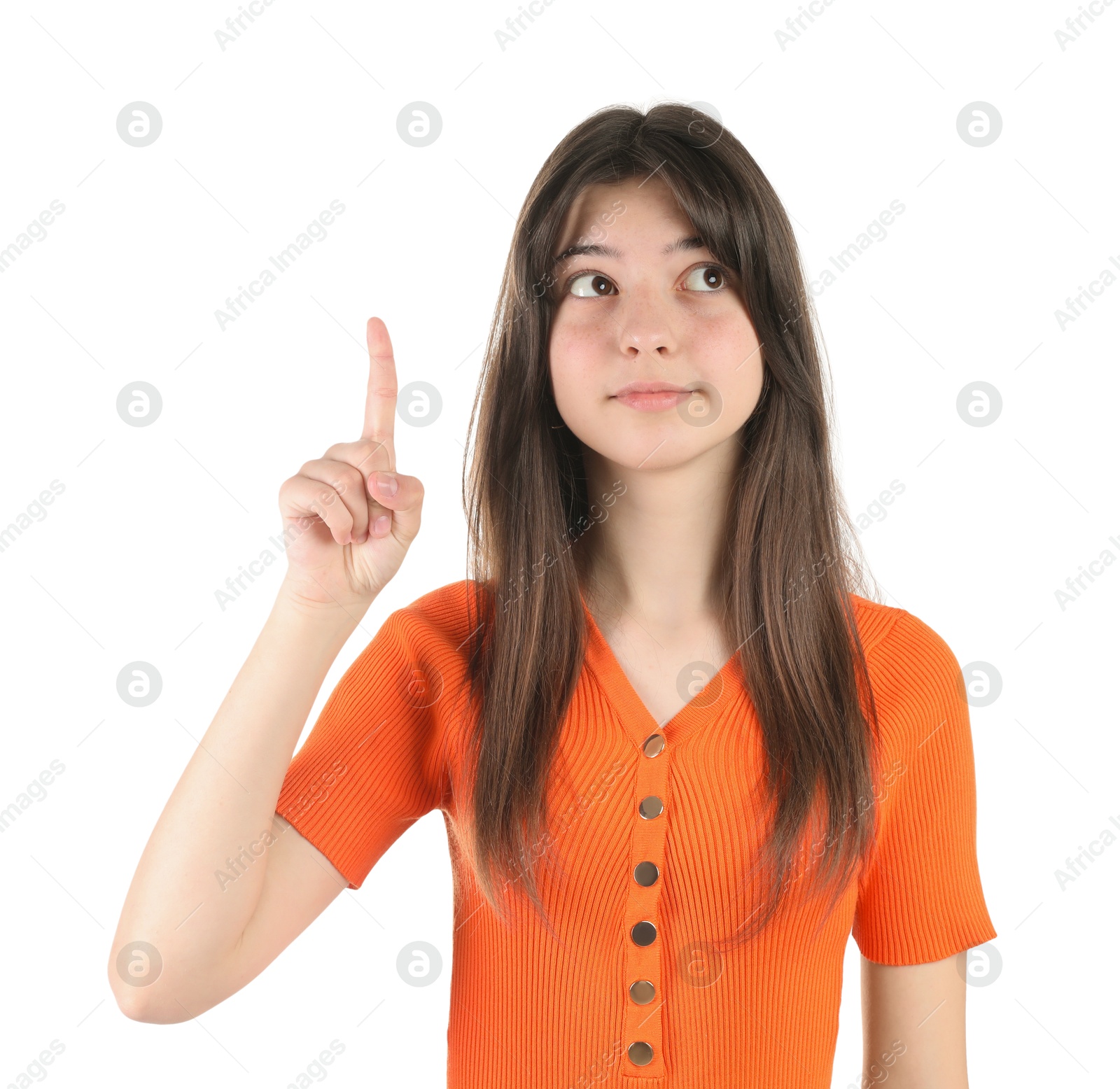 Photo of Portrait of cute teenage girl pointing at something on white background