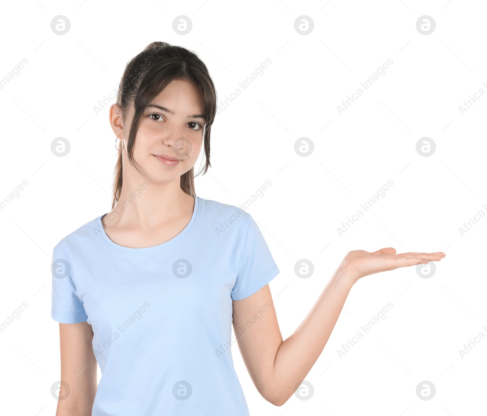 Photo of Portrait of cute teenage girl holding something on white background