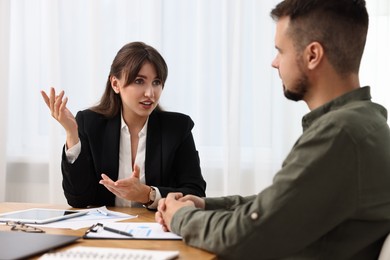 Photo of Consultant working with partner at table in office. Business meeting