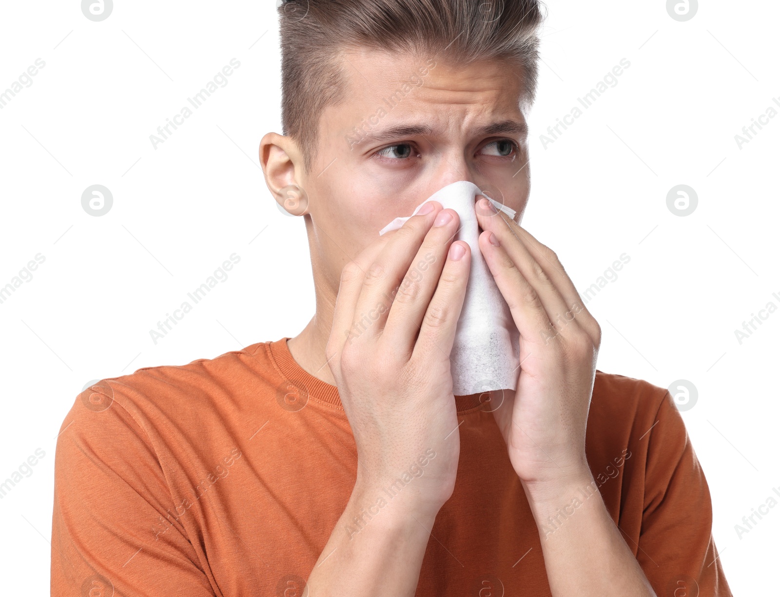 Photo of Young man with tissue suffering from sinusitis on white background