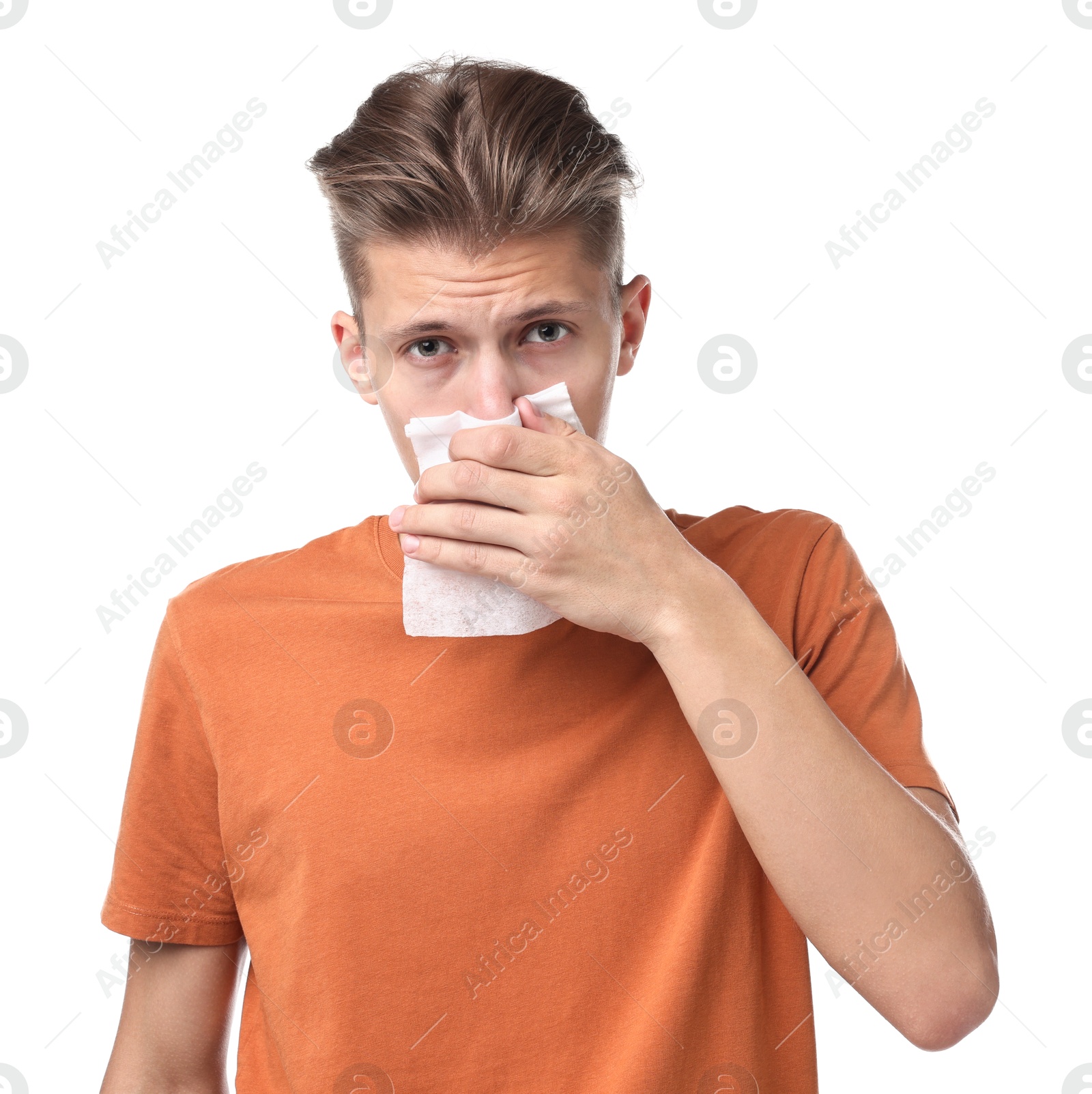 Photo of Young man with tissue suffering from sinusitis on white background