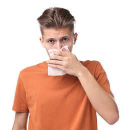 Photo of Young man with tissue suffering from sinusitis on white background