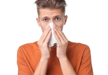 Photo of Young man with tissue suffering from sinusitis on white background