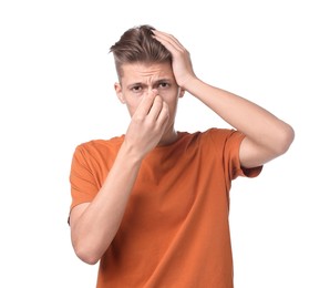 Young man suffering from sinusitis on white background