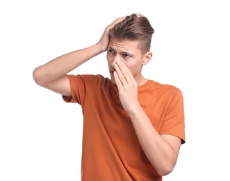 Young man suffering from sinusitis on white background