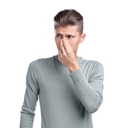 Young man suffering from sinusitis on white background